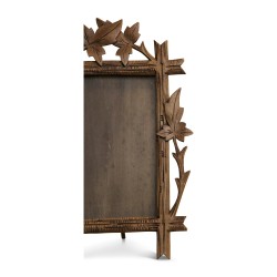carved wooden frame decorated with vine leaves. Brianz…