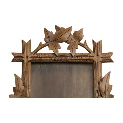 carved wooden frame decorated with vine leaves. Brianz…