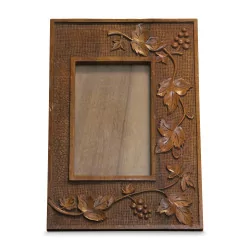 carved wooden frame decorated with vine leaves and grapes …