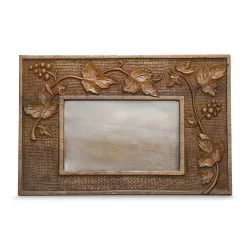 carved wooden frame decorated with vine leaves and grapes …