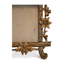 carved wooden frame decorated with leaves and flowers. Brianz…