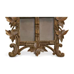 Double carved wooden frame decorated with vine leaves. …