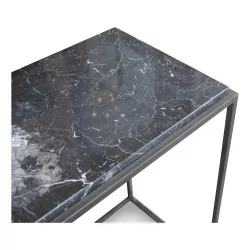 Modern console in patinated raw iron with a black marble top.