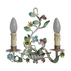 Pair of painted metal sconces adorned with floral decorations.