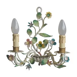 Pair of painted metal sconces adorned with floral decorations.