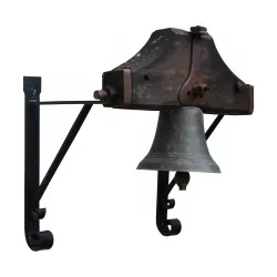 Bronze school bell on a wrought iron wall bracket...