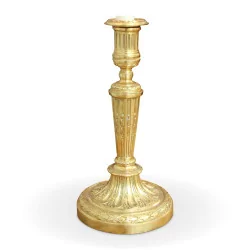 Pair of Louis XVI candlesticks in bronze with golden patina.