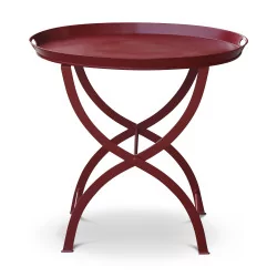 Table with red lacquered metal top and X-shaped base and …