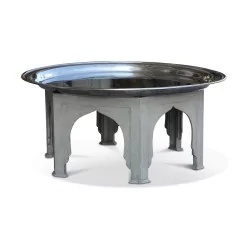 Une table basse avec plateau en métal argenté