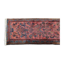 Oriental carpet in red, blue and yellow tones.