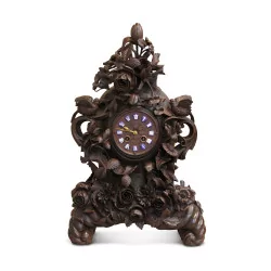 carved wooden clock adorned with rose and birds. Forest …