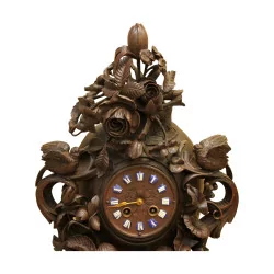 carved wooden clock adorned with rose and birds. Forest …