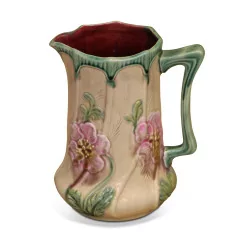 slip pitcher decorated with flowers.