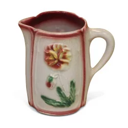 Small slip pitcher decorated with flowers.