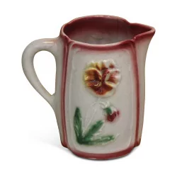 Small slip pitcher decorated with flowers.