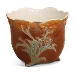 Slip pot decorated with flowers.