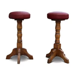 A pair of red leather bar stools
