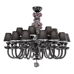 Carved black crystal chandelier with decorative hand-painted ceramic flowers.