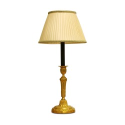 pair of candlestick lamps in gilt and chiseled bronze, with …