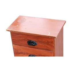 A bedside table with four painted wooden drawers, professional furniture.