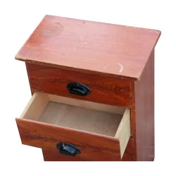 A bedside table with four painted wooden drawers, professional furniture.