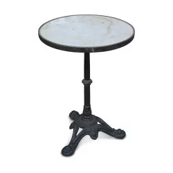 A bistro table with circular marble top
