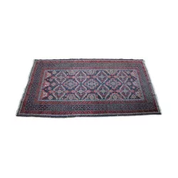 A Pakistani/Afghan red blue wool rug.
