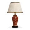 Une lampe en céramique rouge et or avec pied en bois - Moinat - Lampes de table