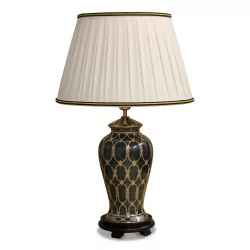black and gold ceramic lamp with a wooden foot and white empire lampshade with black and yellow border.
