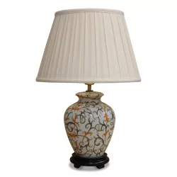 Cream orange and green ceramic lamp with a wooden foot and white empire lampshade.