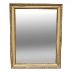 A executive mirror in gilded wood, mercury glass.