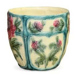 A flower-decorated cachepot, blue, green and red.