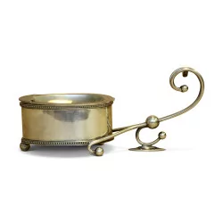 A silver metal sauce boat with pearl decor.