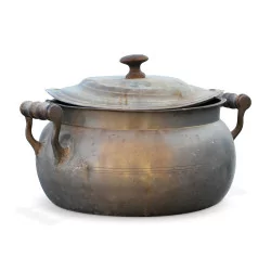 A metal saucepan with a wooden handle.