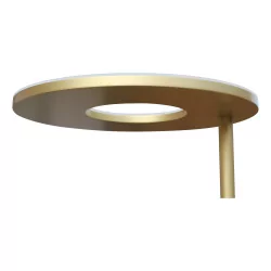 A brass LED floor lamp with its reading arm