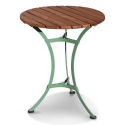 A round garden table with green metal legs