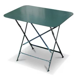 A rectangular garden table in green wrought iron