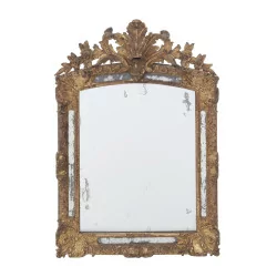 A Regency period glazing beads mirror in carved wood