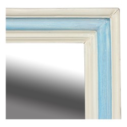 A wooden frame mirror with white and blue patina