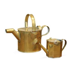 A pair of brass watering cans