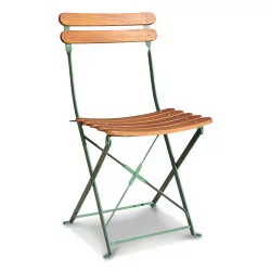 A garden chair in teak and green metal