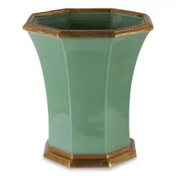 A green porcelain vase with bronze border and foot