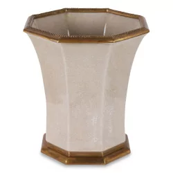 A white porcelain vase with bronze border and foot