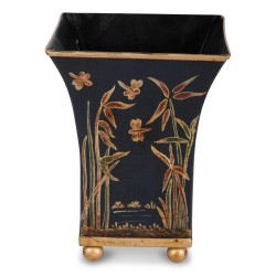 Une jardinière en métal noir et dorée avec décor floral