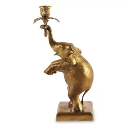 A golden elephant candlestick with a rectangular base (right)
