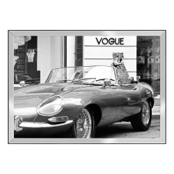 A \"Vogue\" painting under glass with a metal frame