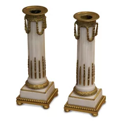 A pair of column-shaped candle holders