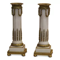 A pair of column-shaped candle holders