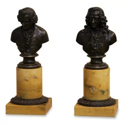 A pair of bronze busts of Voltaire and Rousseau