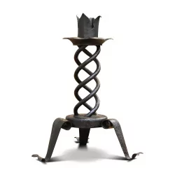 A tripod twisted wrought iron candlestick